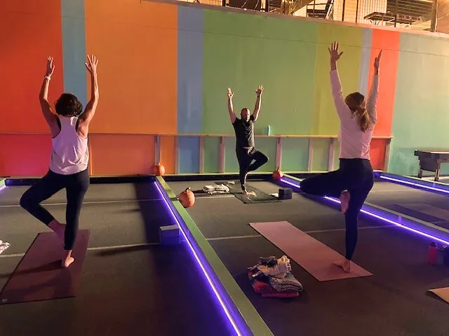 Students in tree pose during a Sunrise Yoga class at Dolce Vita Wellness Spa